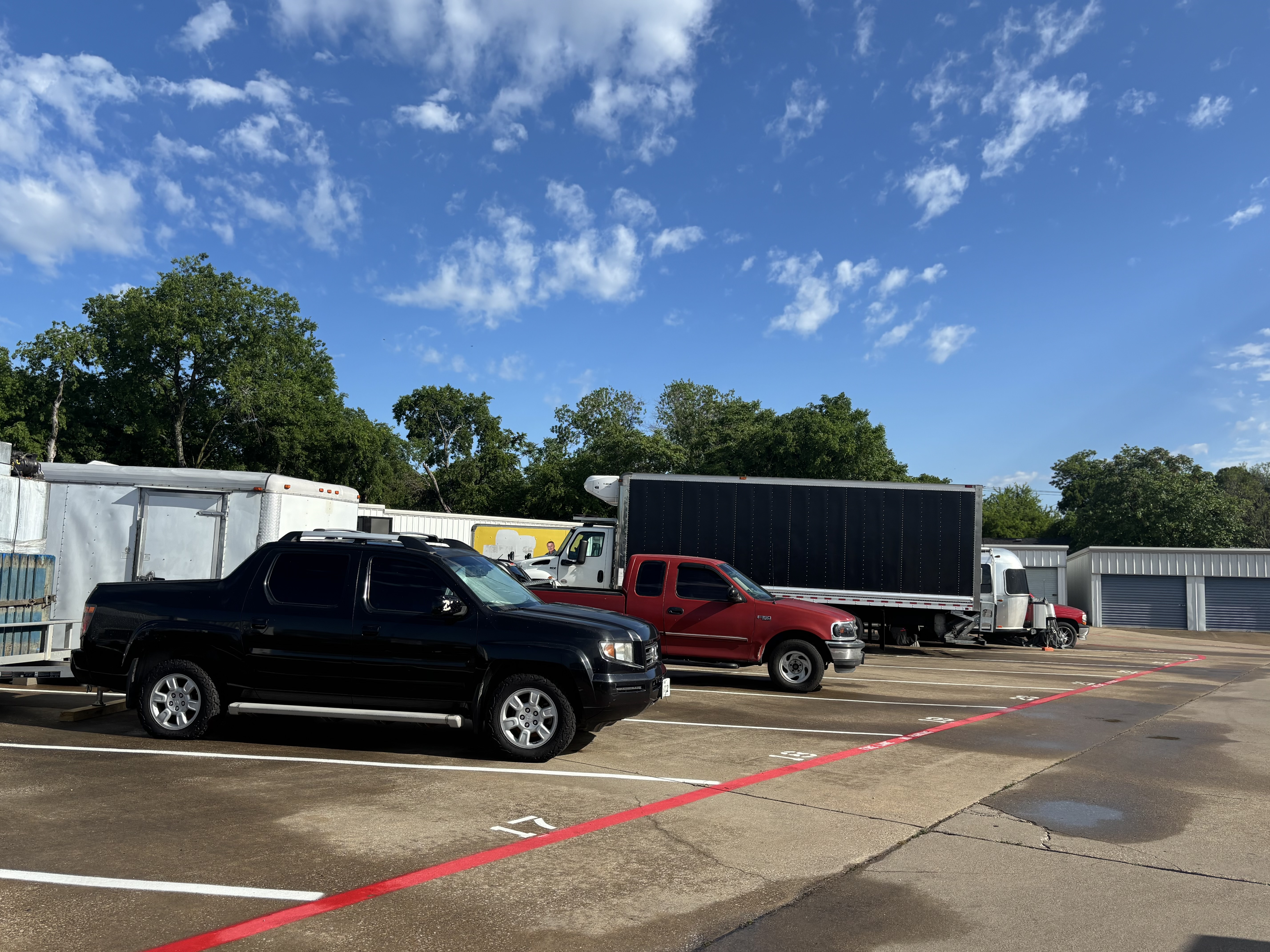 Recreational boat on trailer stored in secure outdoor boat storage facility Waxahachie TX